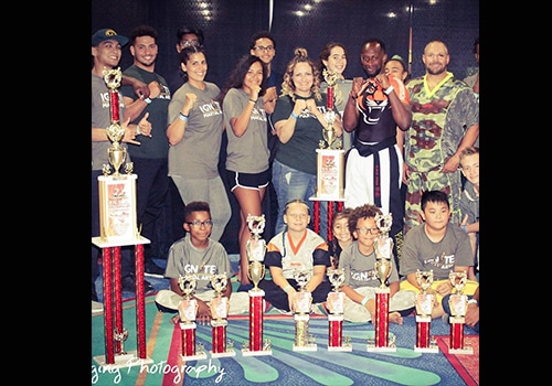 ignite martial arts kids performance team posing with trophies